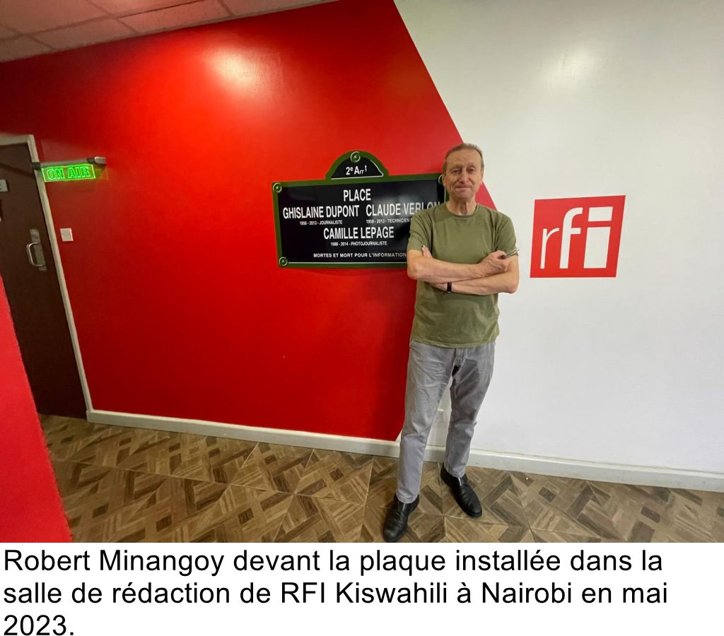 Robert Minangoy devant la plaque installée dans la salle de rédaction de RFI Kiswahili à Nairobi en mai 2023.